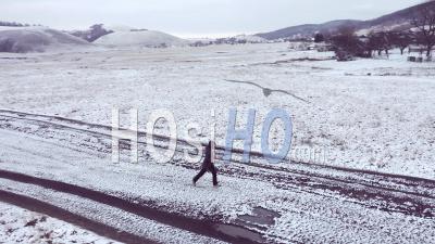 Woman Running In A Cold Morning Viewed From Drone
