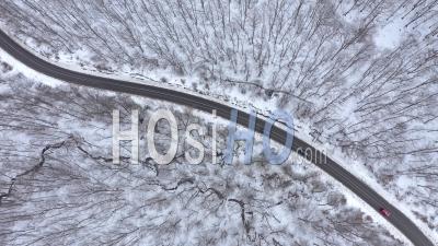 Cars Driving In Winter Forest Viewed From Drone