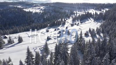 Flying Over Snow Covered Mountain Village - Video Drone Footage