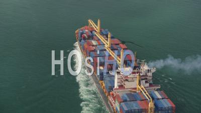 Hong Kong Birdseye View Flying Low Around Large Cargo Ship Passing By - Video Drone Footage