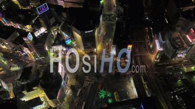 Japan Tokyo Aerial Birdseye View Flying Around Famous Shibuya Intersection Area Night - Video Drone Footage