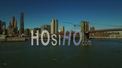 Nyc New York Usa Flying Low Over A Large Barge On East River And Over The Brooklyn Bridge - Video Drone Footage