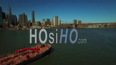 Nyc New York Usa Flying Low Over East River With Large Barge And Towboat In Frame - Video Drone Footage
