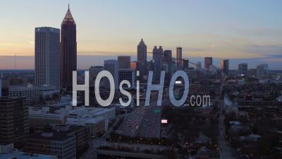 Flying Low Over Freeway Panning With Full Cityscape Views At Dusk. Atlanta Georgia Usa - Video Drone Footage