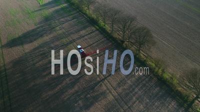Farm Machinery Spraying Glyphosate Herbicide On Farm Crop. - Video Drone Footage