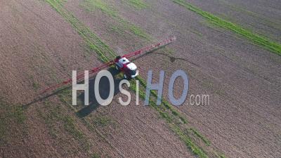 Farm Machinery Spraying Glyphosate Herbicide On Farm Crop. - Video Drone Footage