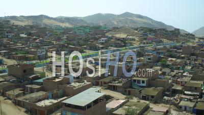 Ventanilla Peru Flying Low Over Urban Poverty Hillside Housing Area. - Video Drone Footage