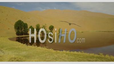 Lake In The Middle Of Sand Dunes In The Gobi Desert In China