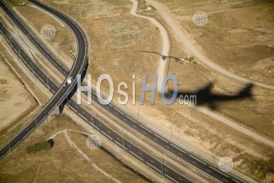 Shadow Of A Flying Airplane Over A Highway In Spain - Aerial Photography