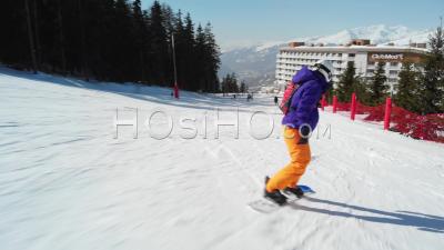 Snowboarder Tracking Shot On Ski Slopes