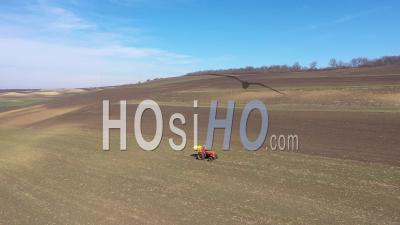 Video Drone Footage Of Agricultural Field, Meadow And A Tractor