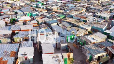 Aerial View Over Ramshackle Tin Roofs Of Gugulethu, One Of The Poverty Stricken Slums, Ghetto, Or Townships Of South Africa - Video Drone Footage