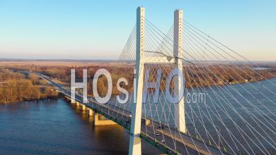 Aerial Video Drone Footage Of Trucks Crossing A Bridge Over The Mississippi River At Burlington, Iowa, Suggesting Infrastructure, Shipping, Trucking Or Transportation