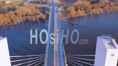 Aerial Video Drone Footage Of Cars And Trucks Crossing A Bridge Over The Mississippi River At Burlington, Iowa, Suggesting Infrastructure, Shipping, Trucking Or Transportation
