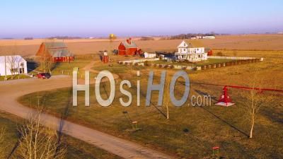 Aerial Video Drone Footage Over A Classic Farmhouse Farm And Barns In Rural Midwest America, York, Nebraska