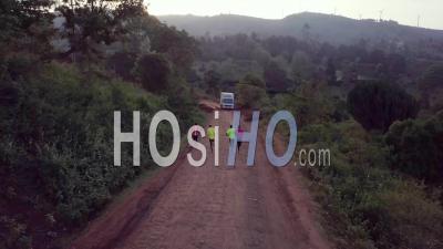 Aerial View Kenya Runners And Olympic Athletes Training On A Dirt Road In Ngong Hills, Nairobi, Kenya, Africa - Video Drone Footage