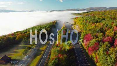 Aerial View Over A Highway Through The Fog In Fall In New England - Video Drone Footage