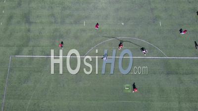 Aerial View Over An Amateur Soccer Match On A Soccer Field - Video Drone Footage
