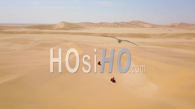 Vue Aérienne Sur Des Vélos Vtt Traversant Les Dunes De Sable Du Désert En Namibie, Afrique -Vidéo Drone