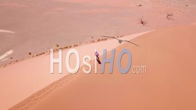 Aerial View Over A Man Hiking In The Rugged Desert Landscape And Sand Dunes Near Dune 45 In Namibia, Africa - Video Drone Footage