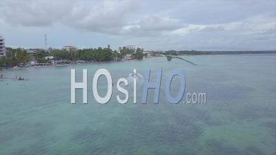 Aerial View Over Tourists Riding A Banana Boat In The Boca Chica Beach District In The Dominican Republic - Video Drone Footage