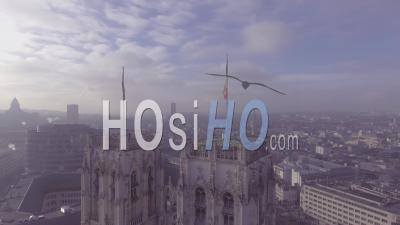Aerial View Of A Mysterious Foggy Day In Brussels, Belgium With Cathedral Churches And Spires In Foreground - Video Drone Footage