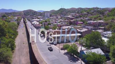 Aerial View Moves Across The U.S Mexican Border Wall Fence Near The Town Of Nogales - Video Drone Footage