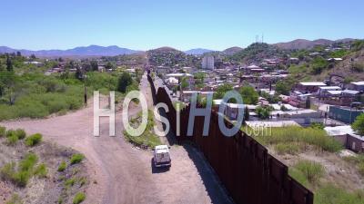 Aerial View Over A Border Patrol Vehicle Standing Guard Near The Border Wall At The Us Mexico Border At Tecate - Video Drone Footage