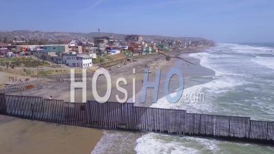 Aerial View Of The U.S. Mexico Border Fence In The Pacific Ocean Between San Diego And Tijuana - Video Drone Footage