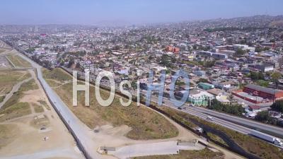 Aerial View Over The Border Wall Fence Separating The Us From Mexico And San Diego From Tijuana - Video Drone Footage