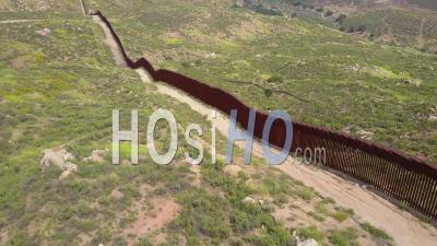 Aerial View Along The U.S Mexican Border Wall Fence - Video Drone Footage