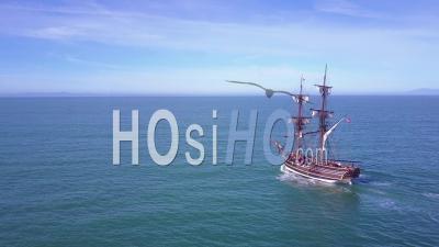 Aerial View Of A Tall Sailing Ship On The Open Ocean By Day - Video Drone Footage