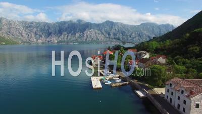 Aerial View Of An Attractive Village On The Shores Of Boka Bay, Montenegro - Video Drone Footage