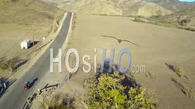Aerial View Over A Man Riding His Harley Motorcycle On The Open Road - Video Drone Footage