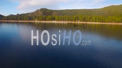 Aerial View Over Lake Tahoe Approaching The Shore And Over Old Pilings In Water - Video Drone Footage