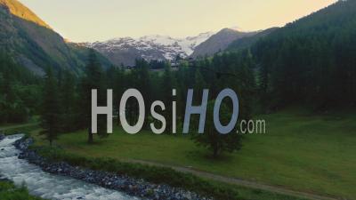 View Of Monte Rosa In The Italian Alps Through Pine Trees At Sunrise - Video Drone Footage