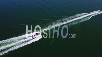 Aerial View Over Two Speedboats Racing Fast Across Blue Water - Video Drone Footage