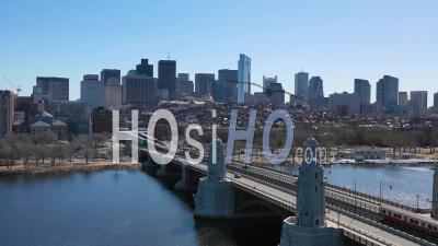 Aerial View Of City Skyline Of Boston Massachusetts With Longfellow Bridge And Subway Train Crossing - Video Drone Footage