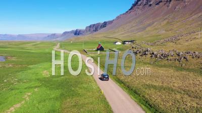 Aerial View Over A Black Van Traveling On A Dirt Road In Iceland, Near Raudisandur Beach In The Northwest Fjords - Video Drone Footage