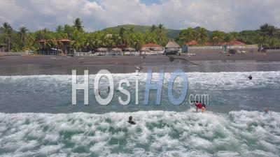 Aerial Video Drone Footage Over Surfers Enjoying The Surf On The Coast Of El Salvador.