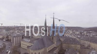 Aerial View Over Church And Cityscape Establishing Of Downtown Luxembourg City - Video Drone Footage