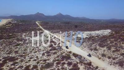 Aerial View Of An Atv Speeding On A Dirt Road Near Cabo, Baja Mexico - Video Drone Footage