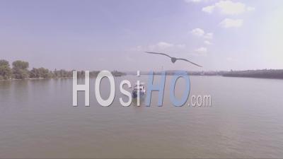 Aerial View Of A Boat Traveling On The Danube Or Sava River Near Belgrade, Serbia - Video Drone Footage