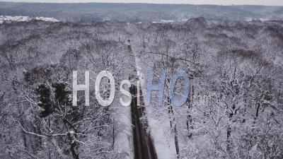 Car Driving On A Snowy Road - Video Drone Footage