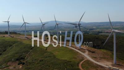 Wind Farm Producing Electricity On Top Of A Hill - Video Drone Footage