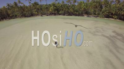 Aerial View Of A Girl Walking In A Tropical Lagoon - Video Drone Footage