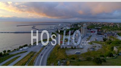 Aerial View Over Traffic On Road With Harbor Background, Visby Sweden - Video Drone Footage