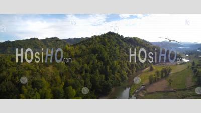 Jungle Covered Mountain Side With River, Philippines - Aerial Photography