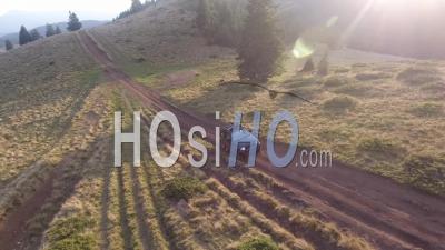 Off-Road Car Driving On A Mountain Dirt Road - Video Drone Footage