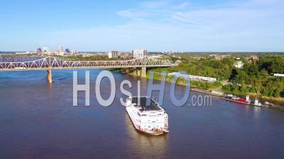 A Mississippi River Paddlewheel Steamship Going Under Three Steel Bridges Near Memphis, Tennessee - Aerial Video By Drone